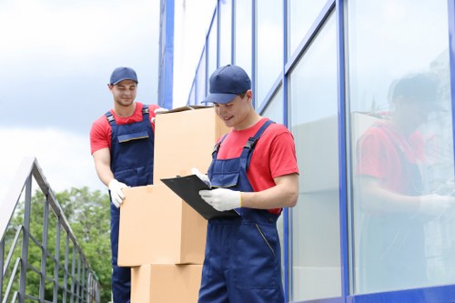 Professional movers loading furniture into a removals van