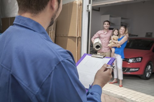 Removal team handling furniture in a Twickenham home