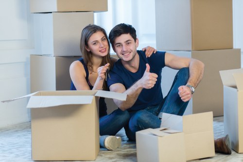 Movers carrying boxes safely through a property